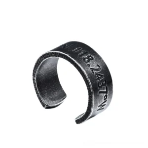 Alternative dark metal open cuff coordinate ring front three-quarter perspective, showcasing vertical engraving on aged stainless steel band