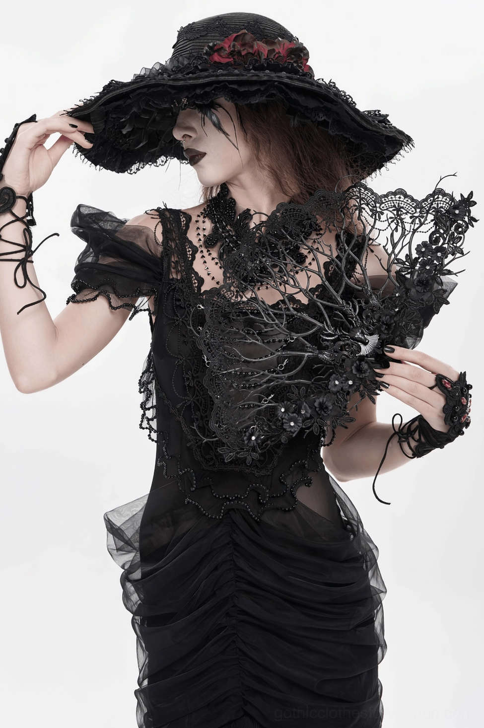 Black gothic lace hand fan displayed to showcase the complete filigree branch structure and ornamental detailing
