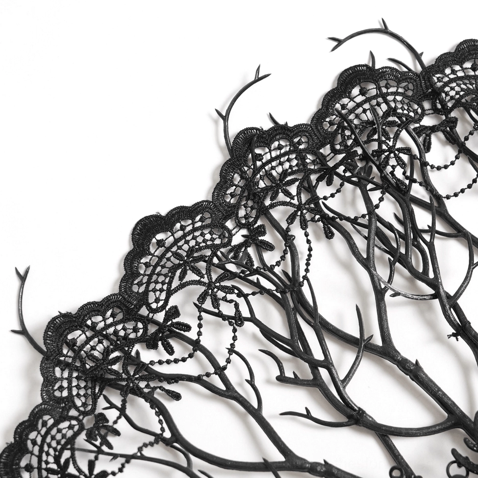Close-up detail of gothic hand fan lace work and skeletal branch frame showing delicate black lace and beaded trim