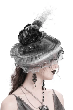 Gothic fascinator hat profile view showcasing black rose decoration and sheer ruffled mesh edge detail
