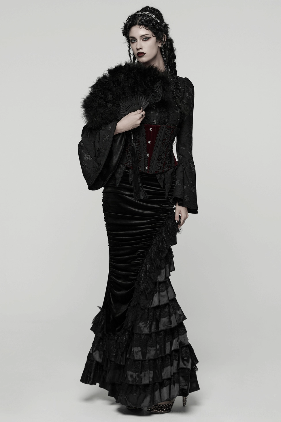 Female model in full gothic aesthetic wearing black feather hand fan with ruffled floor-length gown