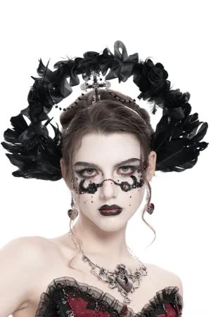 Gothic black halo crown with feathers and iron cross on female model with dramatic makeup, frontal studio view
