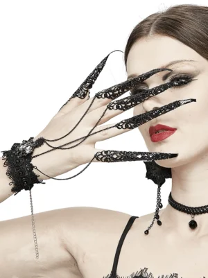 Close-up detailed view of black lace wrist band with metal chain nail claws and hanging chains - gothic jewelry detail