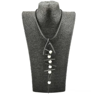 Fish bone rubber pendant necklace displayed on fabric dress form, featuring matte black cord with pearl embellishments in gothic aesthetic