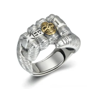 Sterling silver fist skull ring front view overhead angle showing carved knuckle details and two-tone metal finish on white background