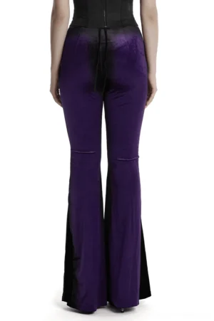 Back view of purple gothic flared pants on model, showing black drawstring waist closure and dramatic flared hem
