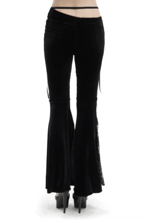 Back view of black velvet gothic trousers showing low-rise waist strap and smooth luxurious velvet fabric