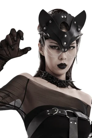 Black gothic fox mask with chains and studs paired with sheer off-shoulder top and leather harness, three-quarter body view