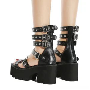 Rear view of black gladiator platform sandals featuring functional zipper closure, adjustable buckle straps, and industrial metal grommets