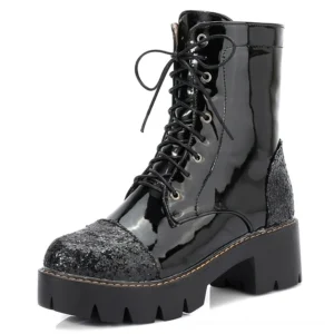 Black patent leather gothic combat boots with glitter toe and heel cap, featuring lace-up closure and thick lug sole - front side view