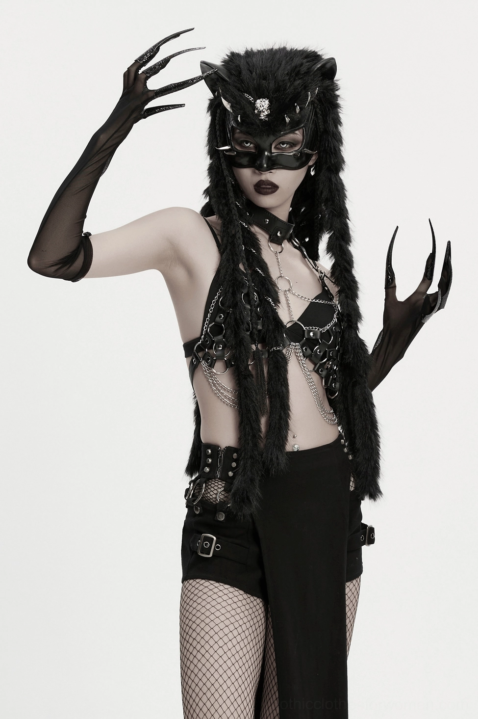 Model with wolf mask and dreadlocks wearing black mesh gothic gloves with sharp claw nails and punk goth outfit, three-quarter side view