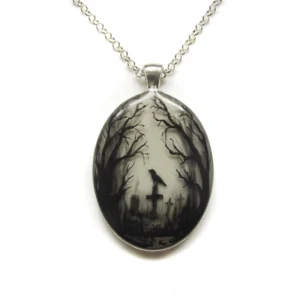 Hand-painted oval gothic graveyard pendant necklace featuring monochromatic raven, tombstone and forest design on white background - neo-gothic dark aesthetic jewelry