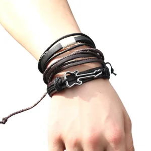 Black and brown leather gothic guitar bracelet worn on wrist side close-up detail view
