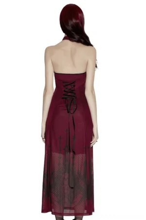 Back view of burgundy gothic halter maxi dress revealing dramatic lace-up back closure and sheer mesh floor-length skirt with church print, model styling