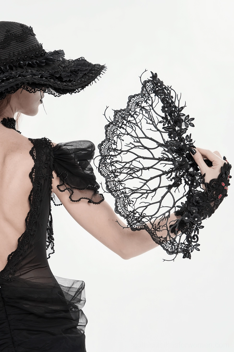 Overhead shot of gothic black lace hand fan highlighting skeletal branch framework and delicate lace composition
