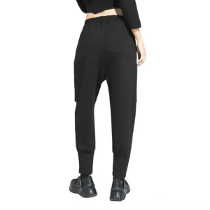 Black gothic harem trousers rear view displaying drop crotch and tapered ankles on female model