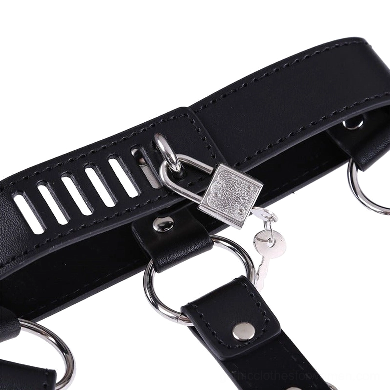 Close-up detail shot of gothic harness hardware showing adjustable slots, padlock mechanism and matching key