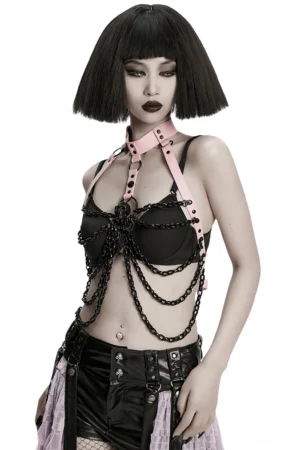 Three-quarter side view of gothic pink leather chest harness showing chain drape and adjustable side buckles
