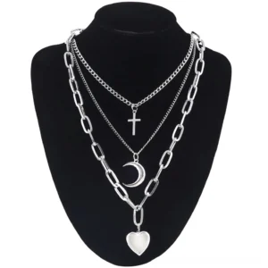 Multi-layered gothic heart chain necklace in silver aluminum on black jewelry mannequin, front close-up view with cross crescent and heart charms