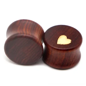 Gothic heart wood ear plugs and tunnels stretcher with double-flared design, brown wood grain with light yellow heart inlay, front flat lay view