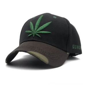 Green hemp leaf embroidered gothic baseball cap front view with dark camouflage brim and embroidery detail