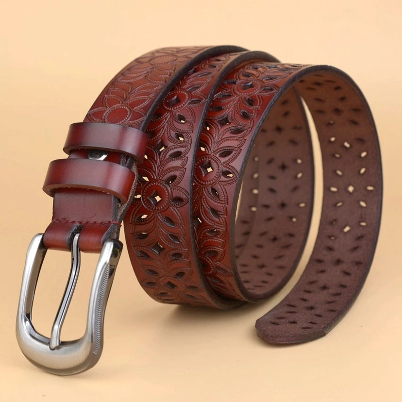 White hollow-carved genuine leather gothic belt three-quarter angle view showcasing the geometric floral cutout design and metal buckle