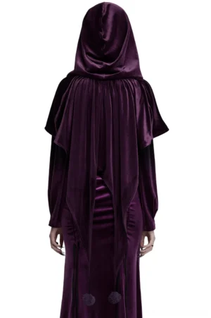Back view of women's purple velvet hooded cape on mannequin, displaying draped velvet texture and pompom tail hem accents from rear angle