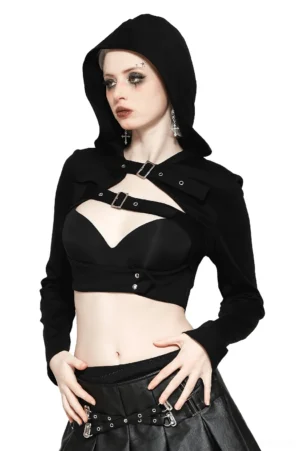Black gothic hooded crop top with front chest buckle cutout and long sleeves, front three-quarter view on model