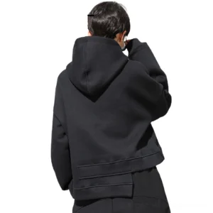 Black cropped hoodie rear view showing attached hood and stacked asymmetrical back hem detail