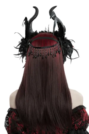 Black demon headdress with horns worn from back, showing beaded chain tassels hanging from forehead area and layered feather detailing