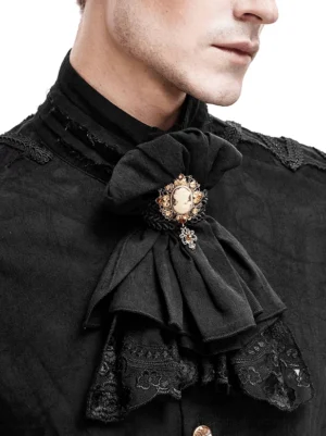 Close-up detail of gothic jabot neckwear showing ruched ruffle, pendant brooch, and delicate lace trim on male model
