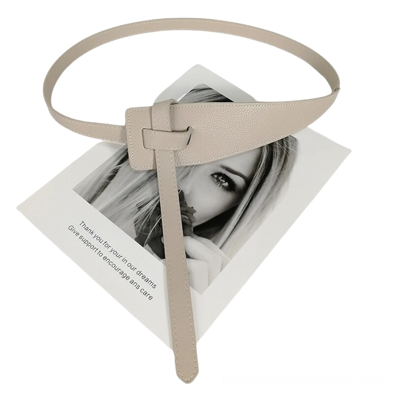 Beige khaki soft PU leather waist belt with knotted decorative buckle and extended tail strap, flat lay display
