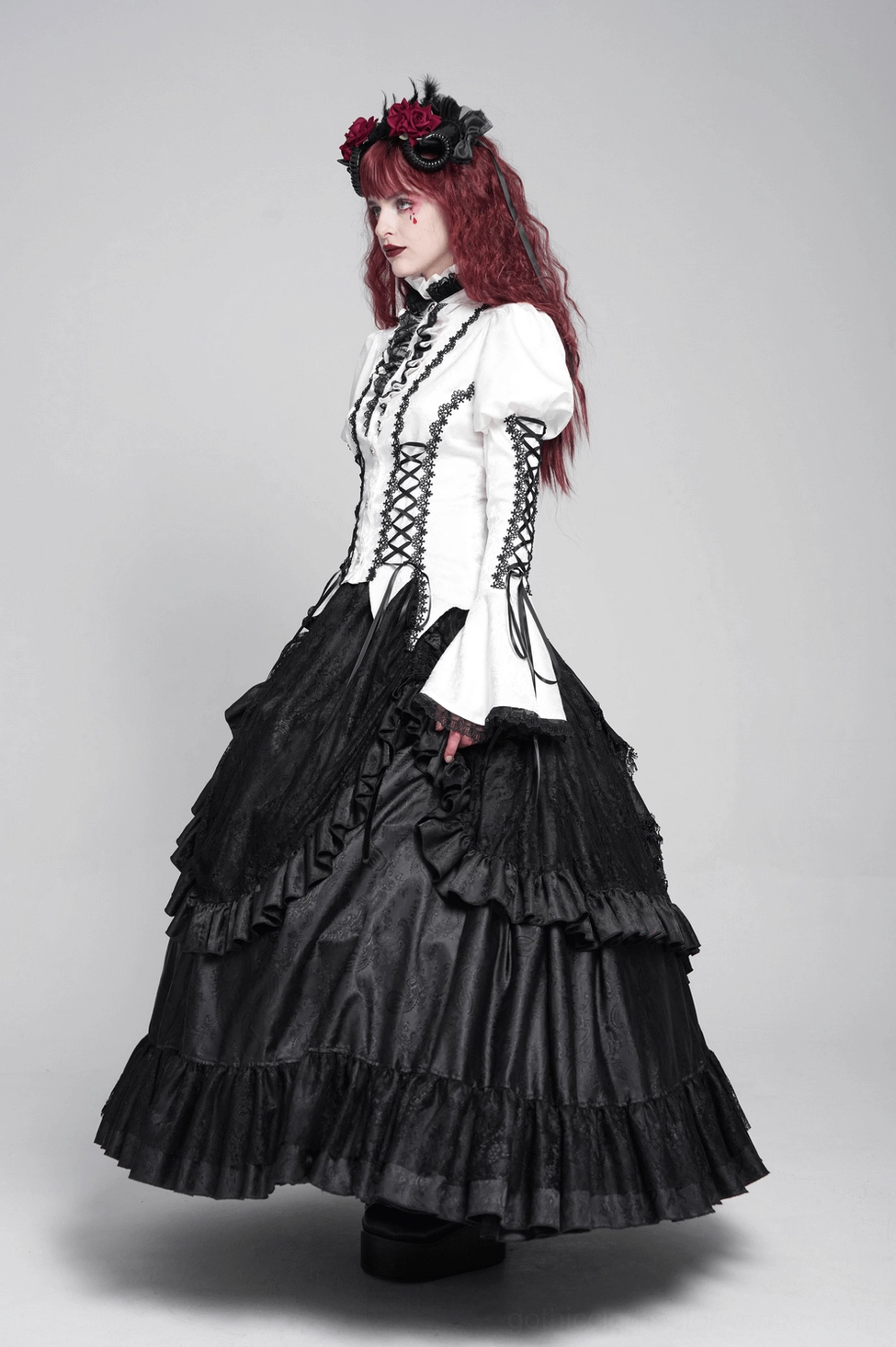 White lace victorian blouse styled three-quarter view showing corset lacing, bell sleeves, and overall gothic aesthetic