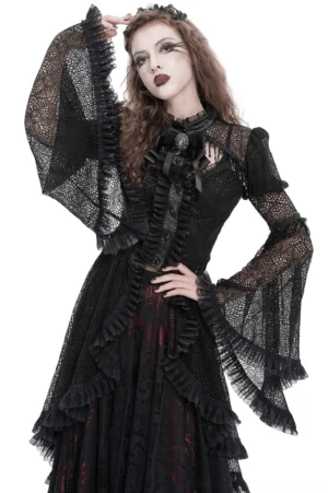 Black Victorian gothic lace cape with cross embellishments, front three-quarter view on model, ruffled layers and bell sleeves visible