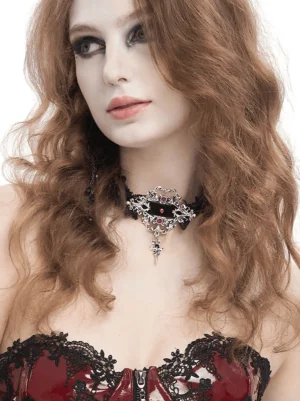 Gothic lace choker with silver cross pendant worn by model, front three-quarter view showcasing delicate black lace trim and crimson ruby rhinestones