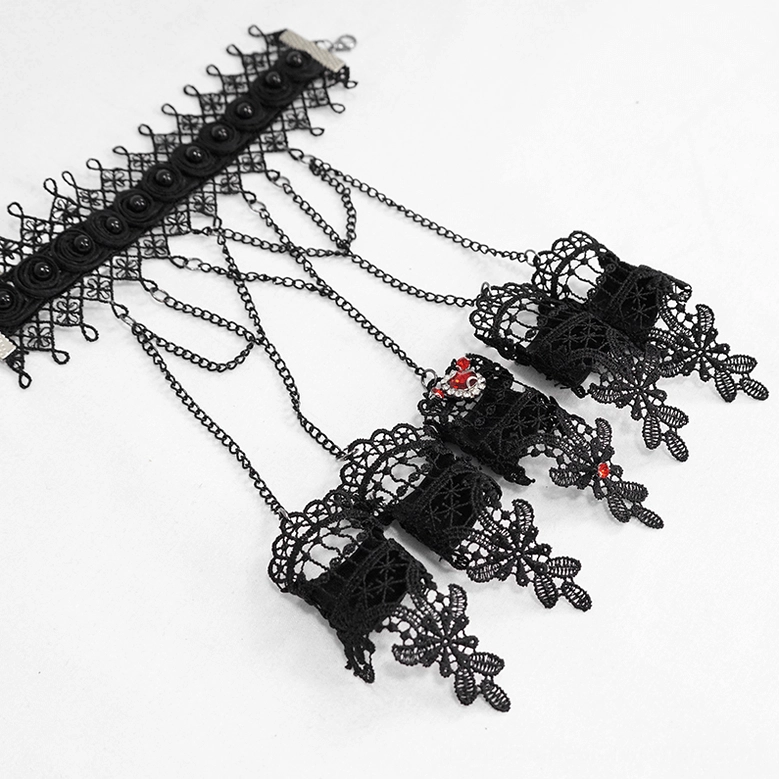 Multiple gothic black lace slave glove sets displayed in flat lay arrangement with red gem accents and multi-chain design