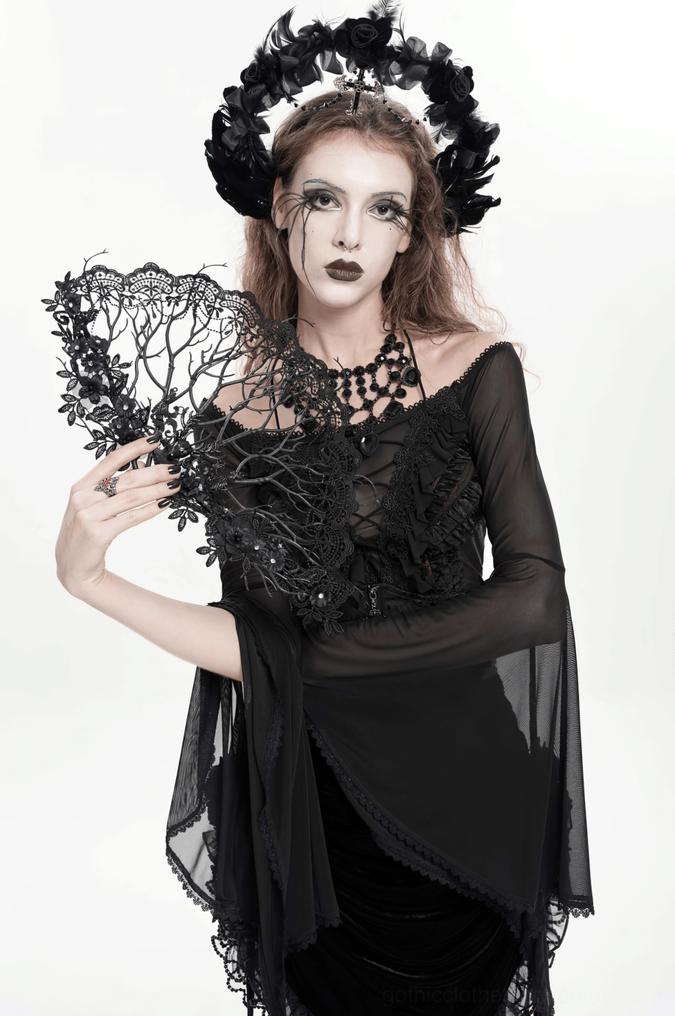 Artistic view of black lace gothic hand fan emphasizing ornate filigree and romantic dark aesthetic