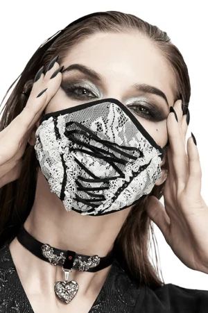 Close-up front view of gothic white lace face mask featuring black lace-up corset front design and adjustable ear straps