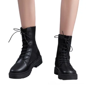 Women wearing black lace-up platform combat boots - gothic ankle boots front view with lug tread sole