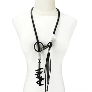 Black gothic lariat necklace with removable spike and pearl pendants displayed on mannequin bust, front view showing silver hardware and faux pearl accents