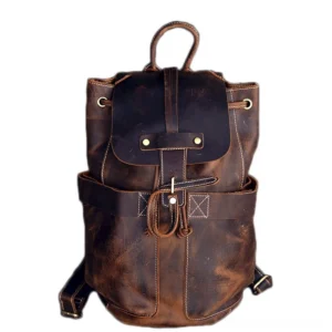 Vintage distressed brown genuine leather gothic backpack with brass hardware and drawstring flap - front view