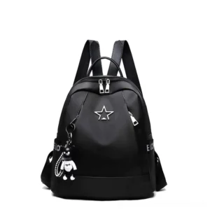 Gothic travel backpack front central view featuring jet black PU leather with silver metal star badge and bear charm decoration
