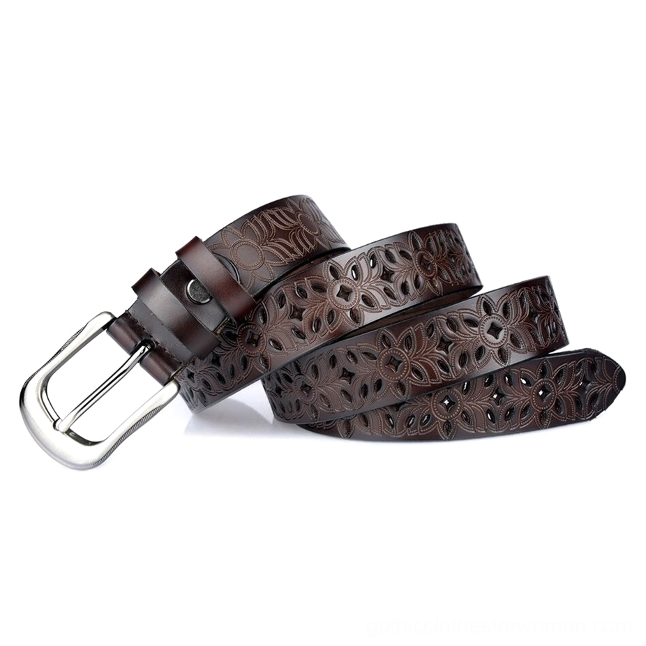 Dark brown hollow-carved leather gothic belt rolled showing the strap construction and silver pin buckle fastening system