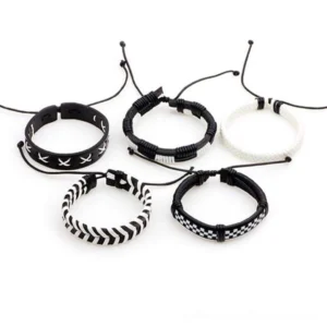 Five adjustable black and white woven leather bracelets with sliding knot closures and mixed geometric designs displayed flat lay