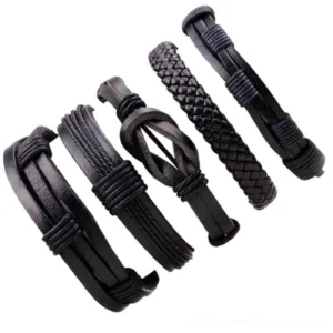 Five assorted black gothic leather bracelets with varied weave and knot styles, flat lay composition showcasing texture diversity