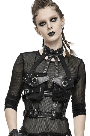 Black faux leather gothic chest harness with metal rivets worn by alternative fashion model, front three-quarter view showcasing adjustable straps and design details