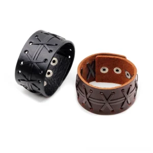 Black and brown leather gothic cuff bracelets flat lay comparison, displaying both color options with cross-stitch design and metal snap fasteners