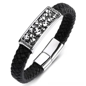 Black leather skull bracelet with braided strap and engraved stainless steel skull plaque, angled side view