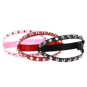 Three-pack spiked leg garters in black red and pink leather with adjustable buckles and silver metal studs overhead product view