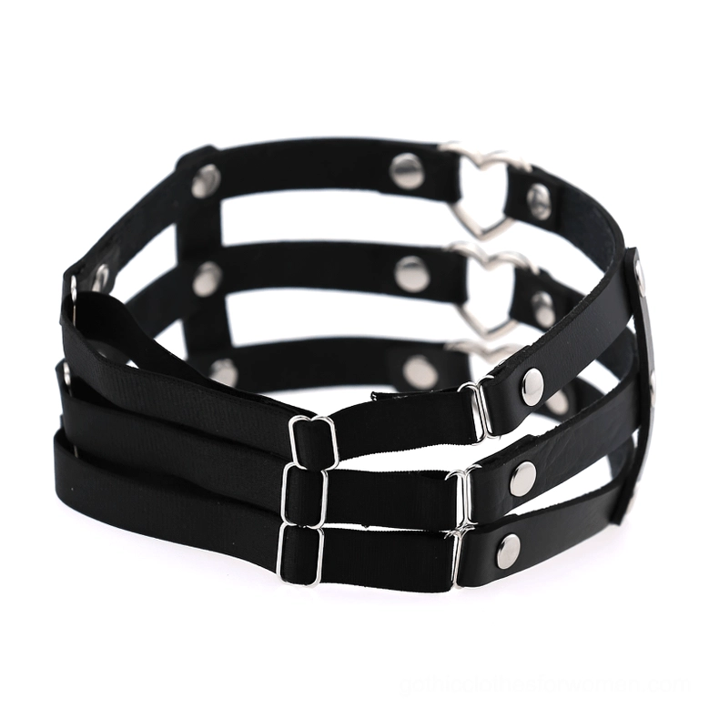 Folded black PU leather thigh harness displaying triple layered straps and metal hardware detail